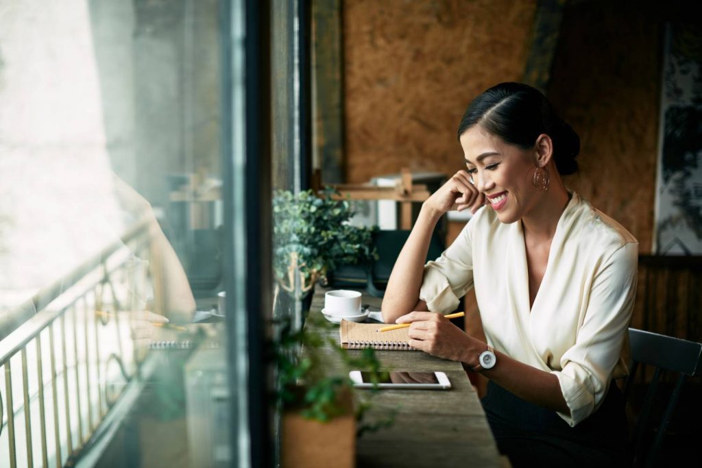 woman calculating expenses on paper